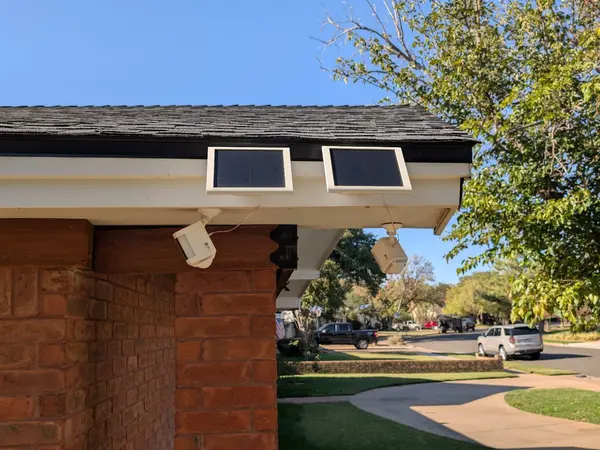 Wireless cameras with solar panels on the roof